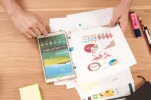 papers and a tablet on a table